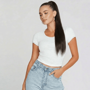 Model showcasing an espresso brown ponytail hair extension with a sleek wrap-around style and casual outfit.