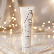 Shampoo tube labeled 'Glossy Locks' on a reflective surface with blurred lights in the background