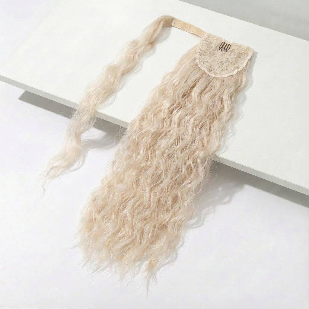 platinum blonde body wave ponytail extension on a light surface