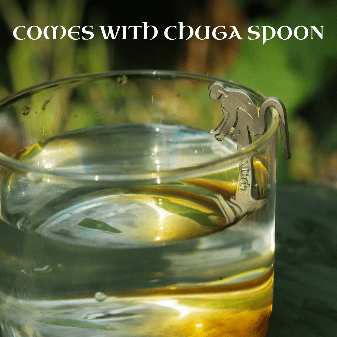 Image of a glass with pure Himalayan shilajit resin, featuring a monkey-shaped chuga spoon.