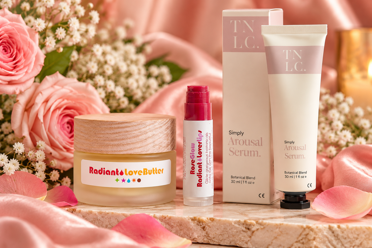 The Sensual Touch gift set featuring Radiant Love Butter, Rose Glow Lover Lips and Simply Arousal Serum in a romantic pink floral setting