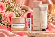 The Sensual Touch gift set featuring Radiant Love Butter, Rose Glow Lover Lips and Simply Arousal Serum in a romantic pink floral setting