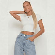 Model showcasing a stylish outfit with a silky straight buttery blonde ponytail hair extension.