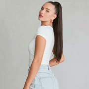Model showcasing a medium brown silky straight ponytail extension with a sleek ponytail hairstyle.