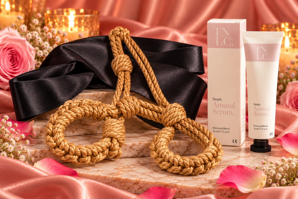 The After Dark gift set with Kanuka rope handcuffs, black fabric blindfold and Simply Arousal Serum against romantic blush satin
